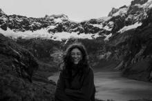 Black and white photo of Student, Lena Wehn, against a backdrop of mountains and a lake