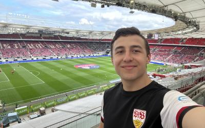 Kaden standing in a soccer stadium in Germany