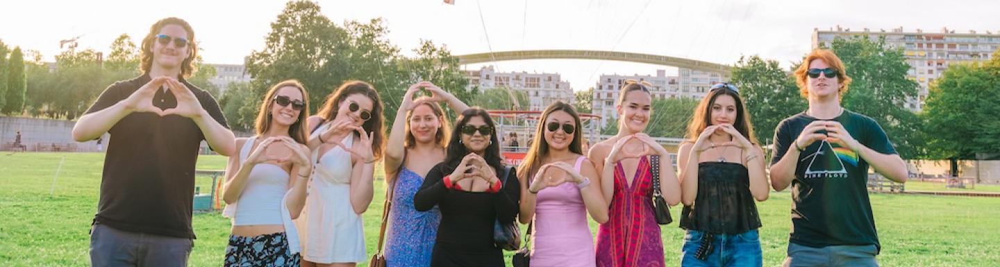 Group of UO students throwing the O in Paris, France