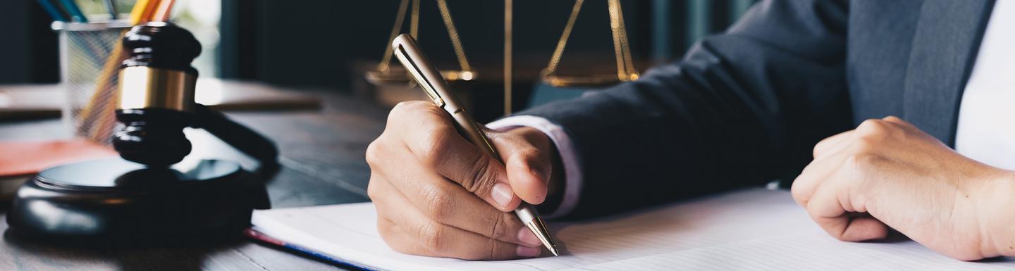 Lawyer working at a desk, writing in a notebook