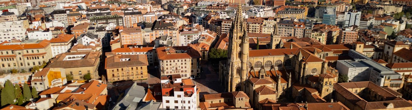 Epic Spanish gothic city panorama. Cinematic aerial view of San Salvador Cathedral and orange roofs in Oviedo, Asturias, Spain