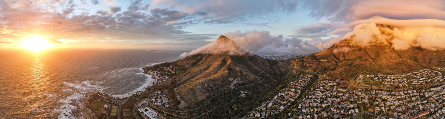 Sunset ocean, mountains, and city