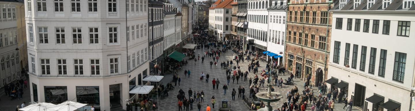 Overhead view of city square with fountain and buildings around it