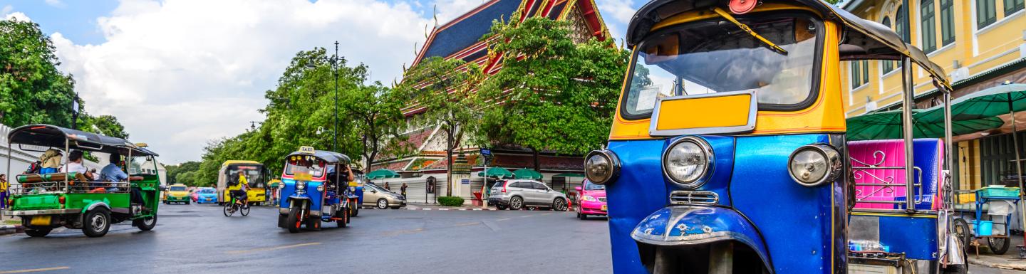 Three wheeled taxi on city street