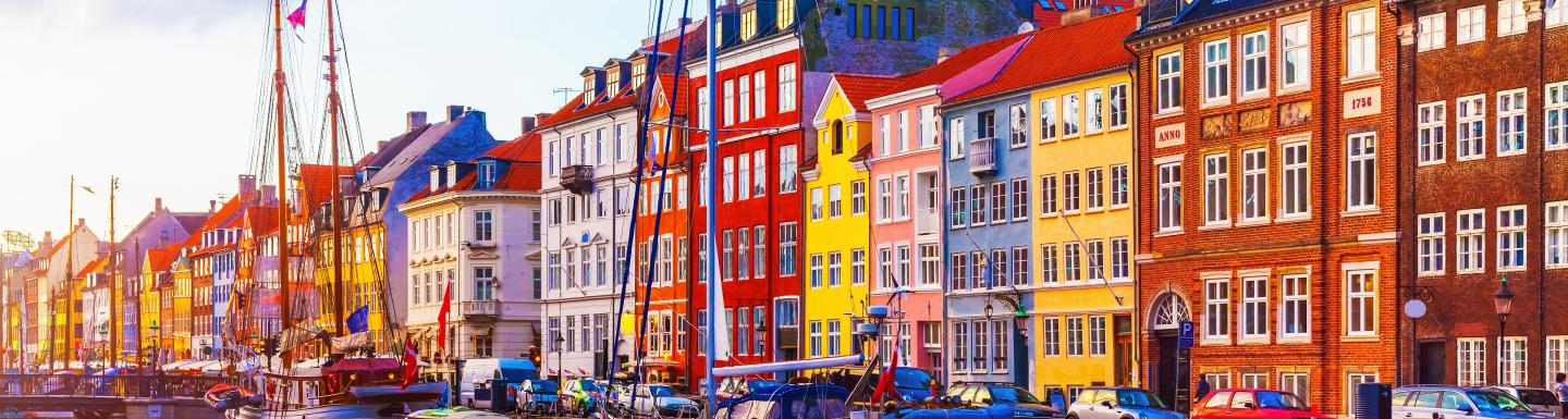 Boats in water in front of colorful buildings in Copenhagen