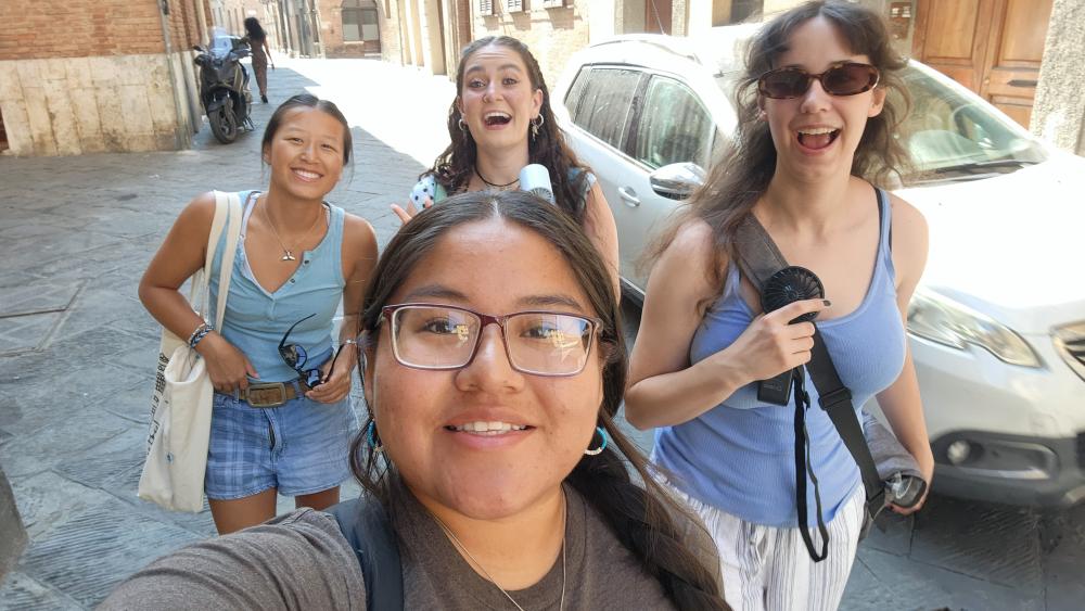 Four students smiling and posing for the camera