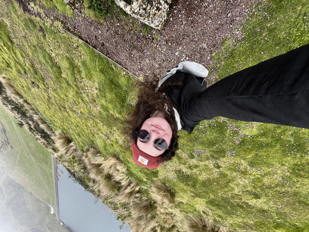 A UO student smiling in a grassy feild