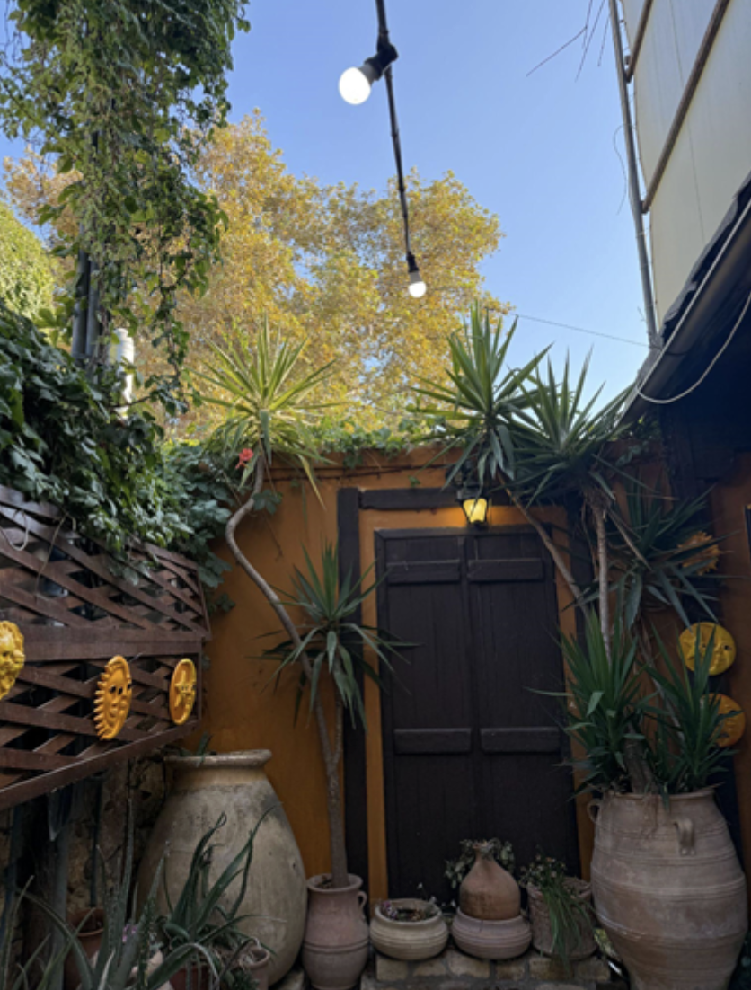 a brown door surrounded by a yellow wall.