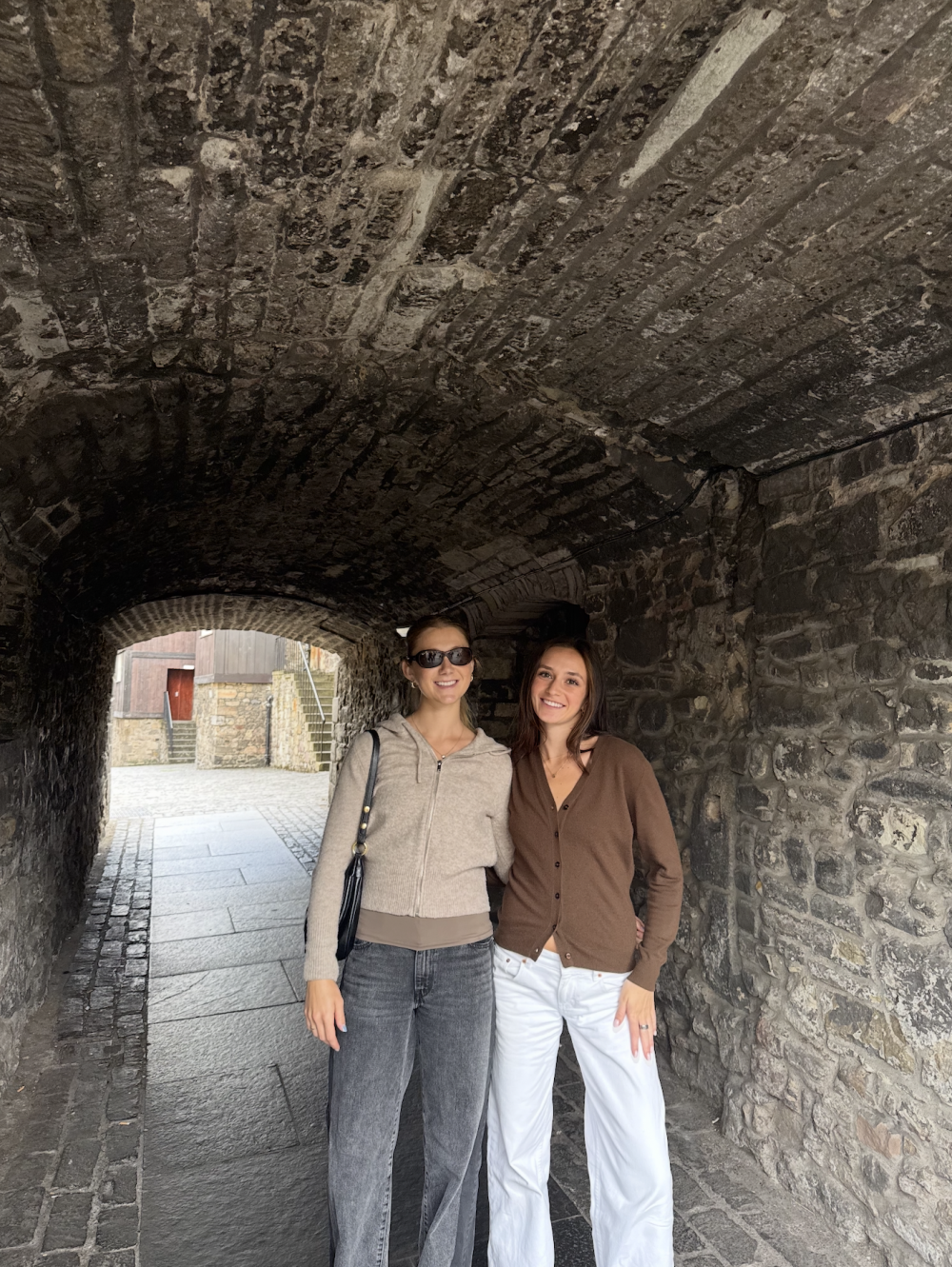 Two students posing in a tunnel