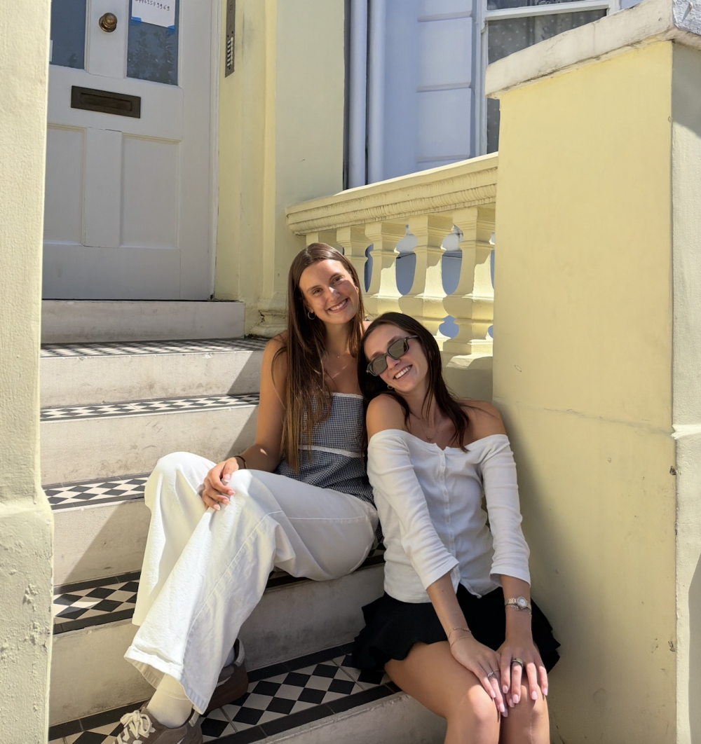 Two students sitting on the stairs