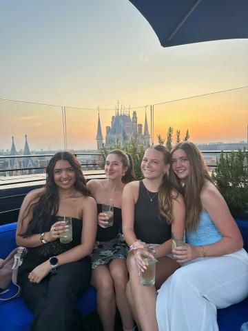 Four students at a rooftop bar during sunset in London
