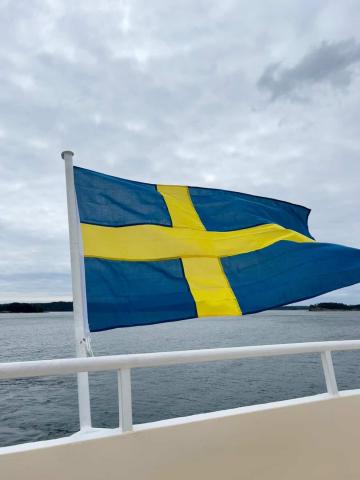 Swedish flag waving in the wind on a boat in Europe