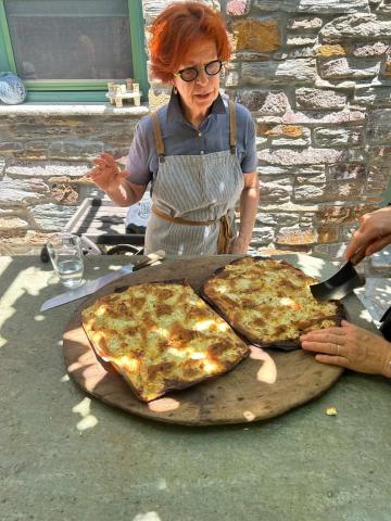 Cooking class in Greece with a local teacher displaying bread