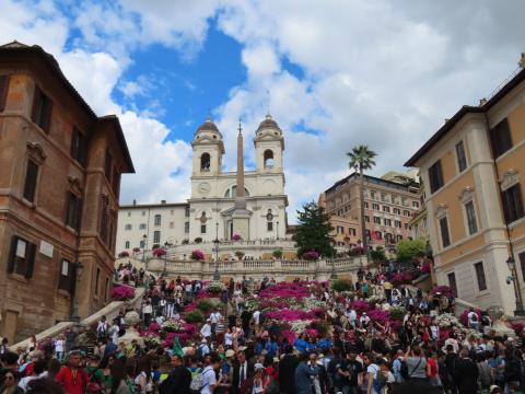 Crowds of people gather outside of a Cathedral to pay tribute to Pope Francis