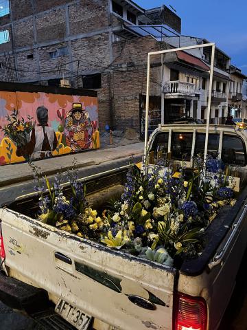 Photo of a truck with flowers in its bed on a street in Quito, Ecuador