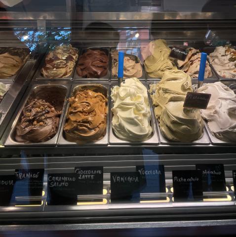 A display case filled with various flavors of gelato.