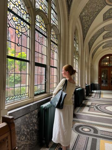 girl looking out window in museum