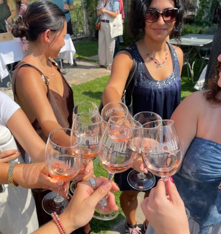 Group of woman holding wine glasses.
