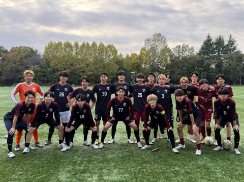 Group photo of a youth soccer team on a grass field, with players wearing different colored jerseys, some numbered, posing for the camera.