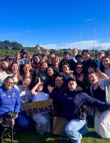 a large group of people hold various blue and yellow signs outside