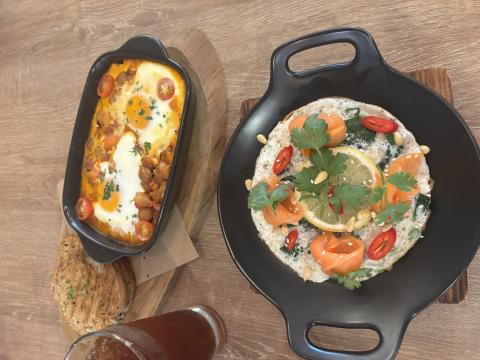 Two food dishes, one with eggs on top, and another with fish