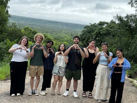 Group of student's studying abroad throwing their Oregon "O"