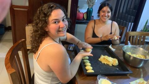 Valeria smiling with cooking local cuisine in Costa Rica with another student