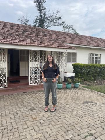 Sadie standing outside of a building in Kisumu, Kenya