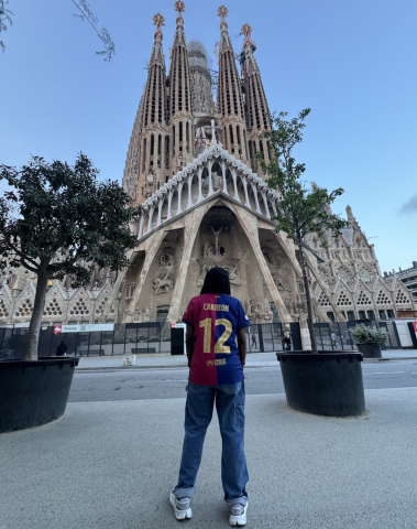Ariel wears a personalized FC Barcelona jersey with a cathedral in the background