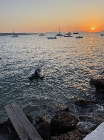 overlook of the water scattered with boats at sunset