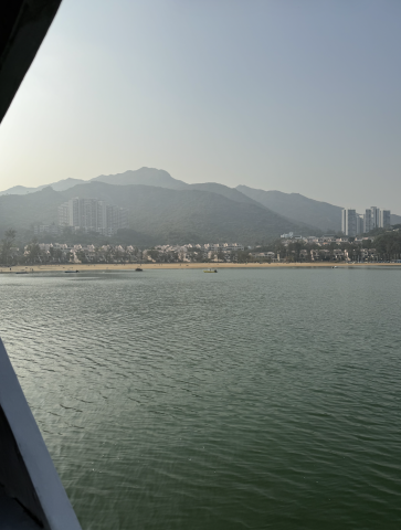 View of Hong Kong from a boat; city buildings and hills are in the background