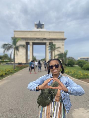 student throwing the O in front of the Black Star Monument in Accra Ghana
