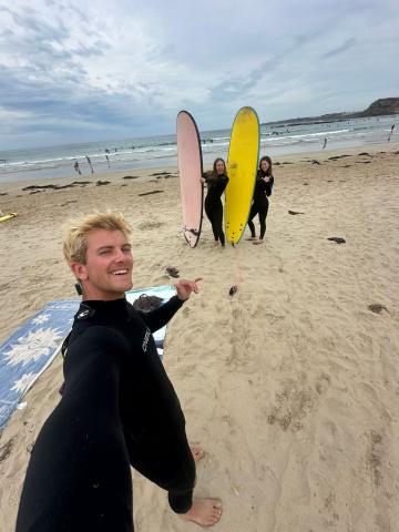 Calvin surfing with friends on Philip Island