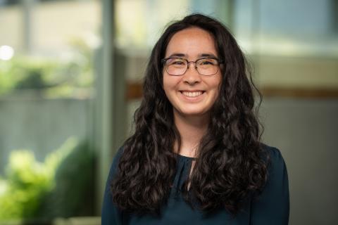 Profile image of Jenn Kuan-Petitti, dark hair and wearing glasses dressed in black