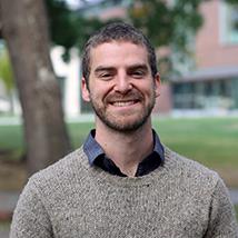 Headshot of Patrick standing outside