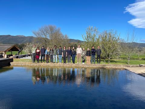 Cohort of architecture students at the RCR architecture firm in Barcelona Spain with mountains in the distance.