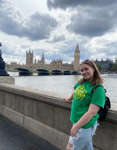 Chloe smiling by the River Thames with the Big Ben in the skyline