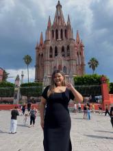 A young woman in front of a cathedral in Queretaro, Mexico.