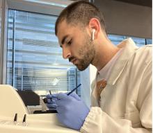 A young man concentrates on lab work