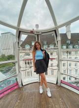 A young woman stands in a carriage on the London Eye