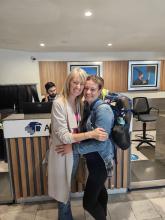 Two women stand in a hotel