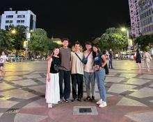 A group of friends standing in a town square in Vietnam