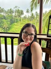 College-aged girl smiling with glasses. 