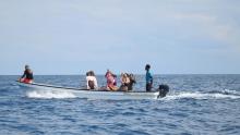 A group of people in a boat in the water