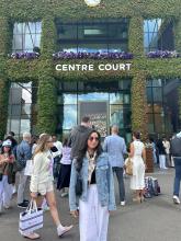College student standing in front of the Centre Court sign in London, United Kingdom. 