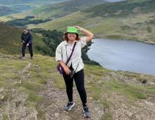 Student standing on a scenic hill in Ireland. 