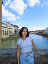 Sarah standing in front of a body of water in Italy