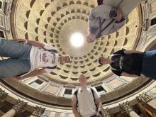 Low point of view photo of 4 college students in a Roman cathedral