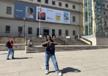 Ariel standing outdoors in front of Reina Sofia, an art museum in Madrid