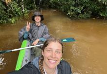 Two people kayaking in a river in Ecuador.